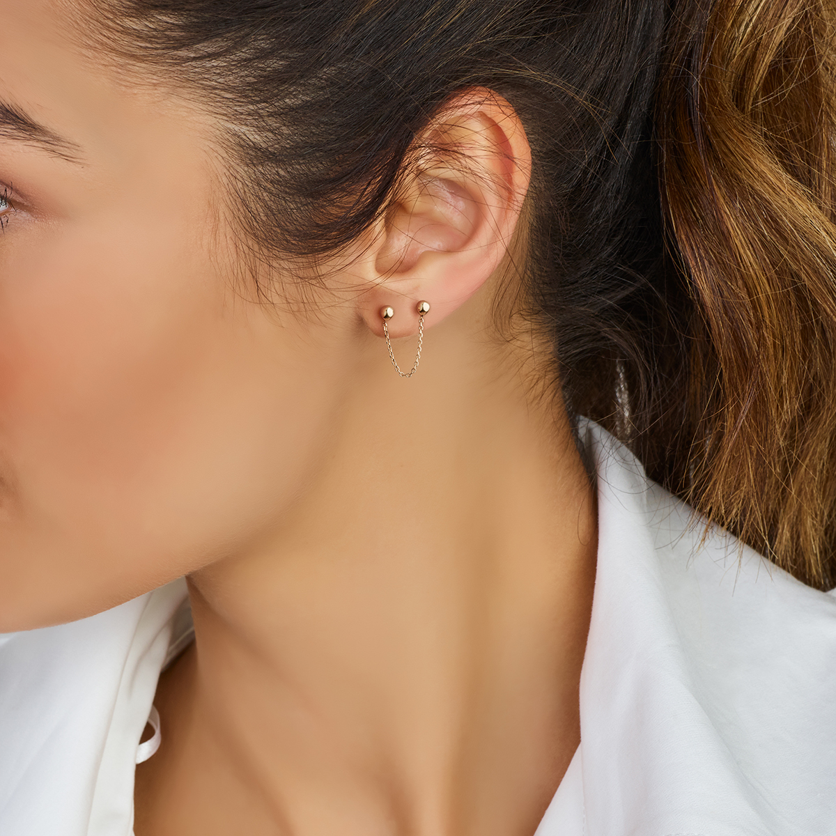 14-karaat gouden oorbel met dubbele knopjes en een kettinkje ertussen 2.8 mm breed - Lengte 30 mm - Per stuk
